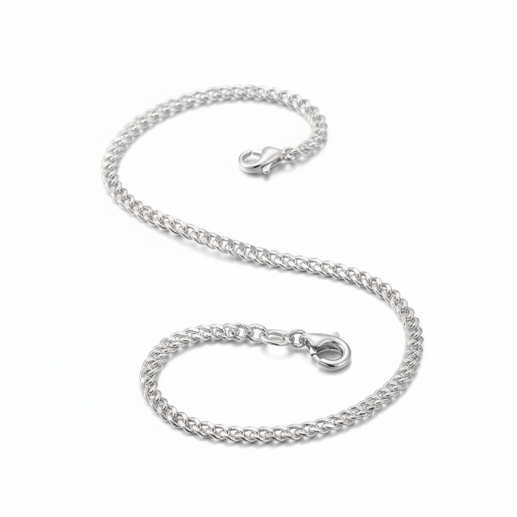 Silver chain bracelet on a soft pink fabric background