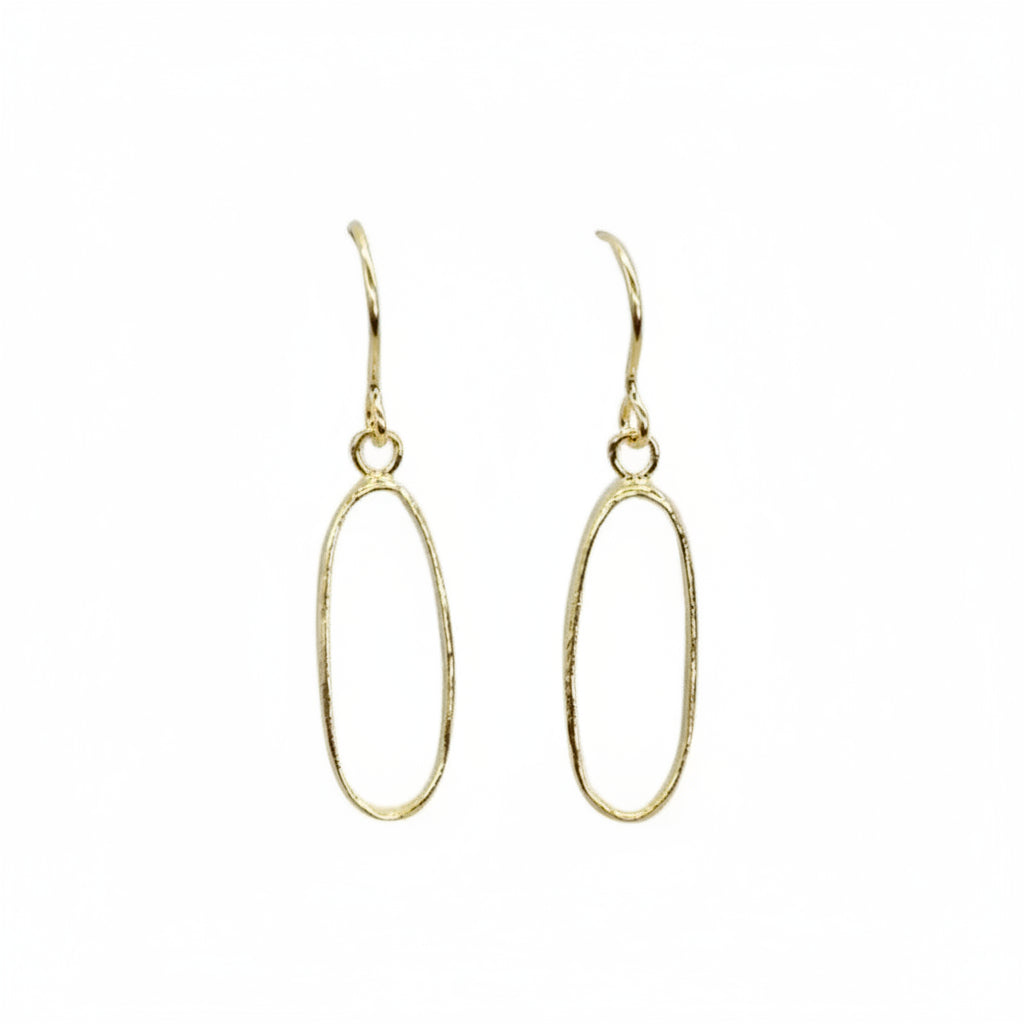 Gold oval earrings on a white background