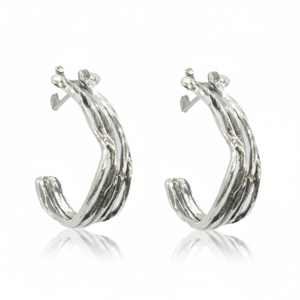 Silver hoop earrings on a white background