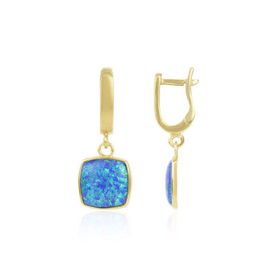 Gold drop earrings with blue-green opal gemstones on a white background.
