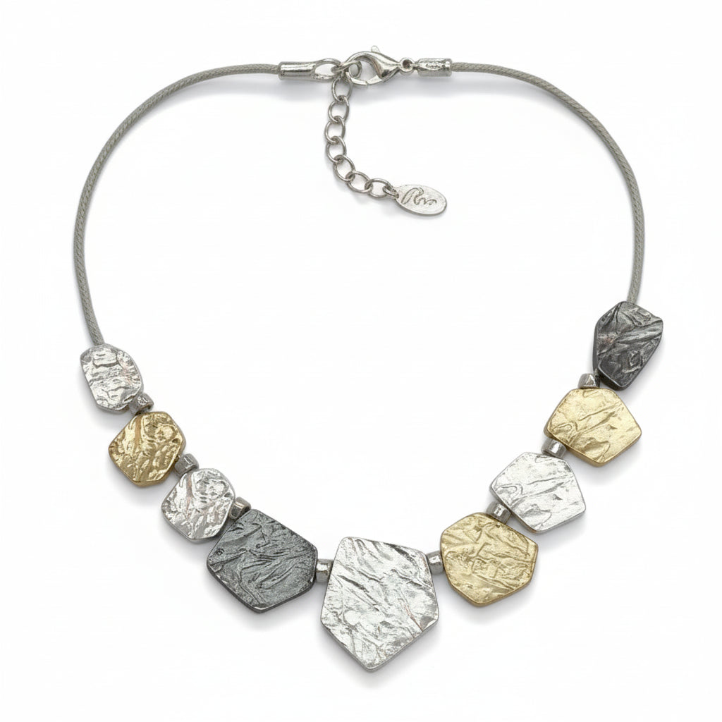 Necklace with textured metal beads on a white background