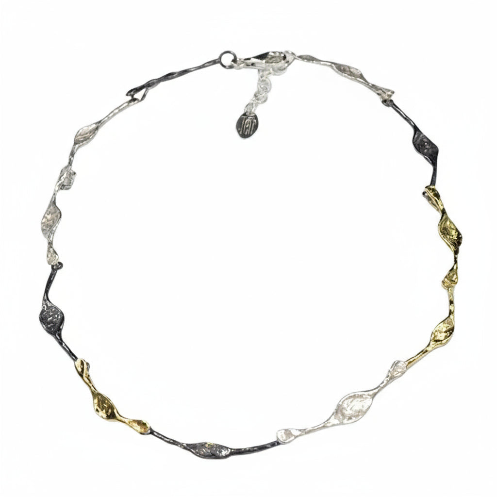 Necklace with gold and silver links on a white background