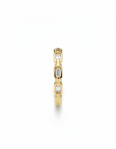 Gold ring with embedded diamonds on a white background