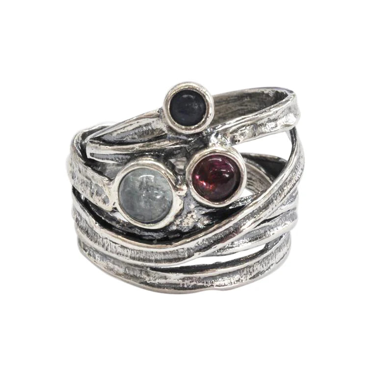 Stack of silver rings with embedded gemstones on a white background