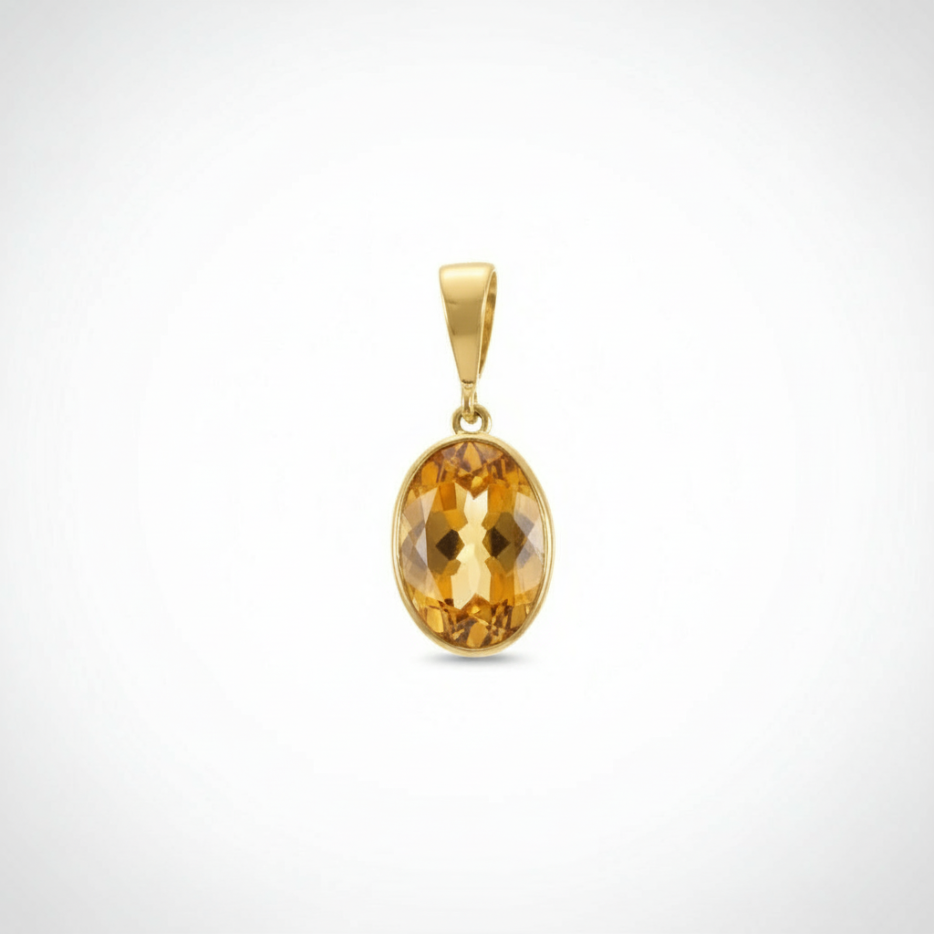 Gold pendant with a yellow gemstone on a white background