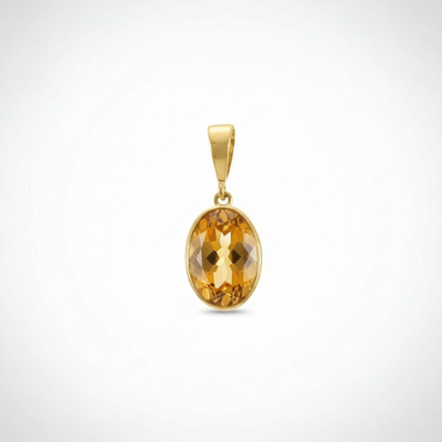 Gold pendant with a yellow gemstone on a white background