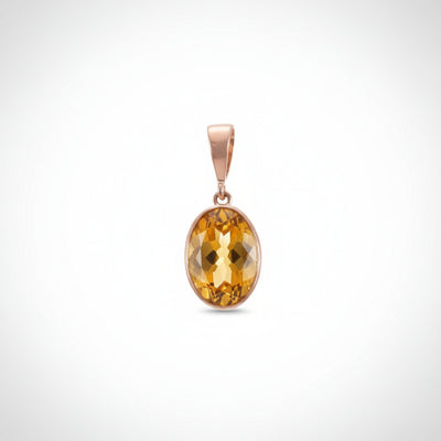 Gold pendant with a yellow citrine gemstone on a white background